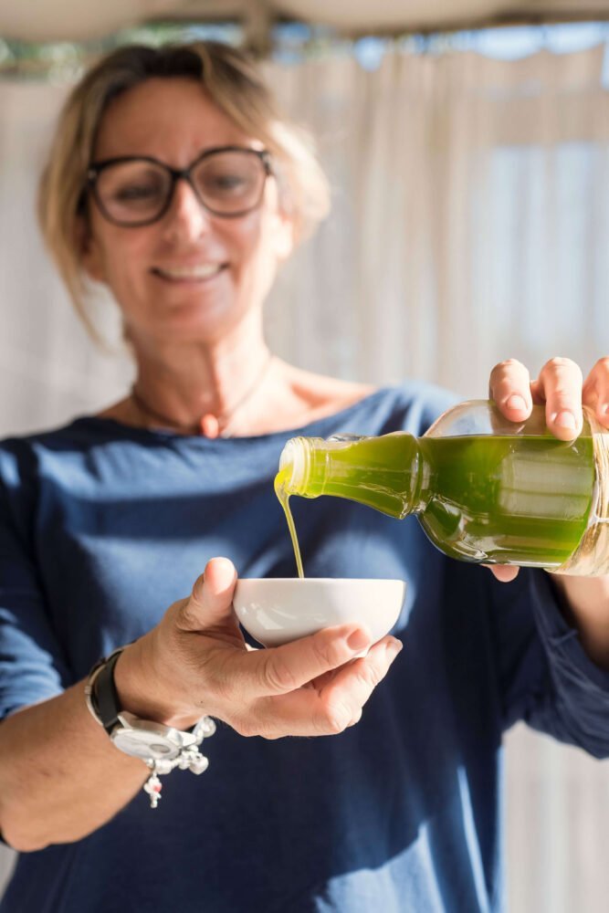 our founder pouring our organic olive oil