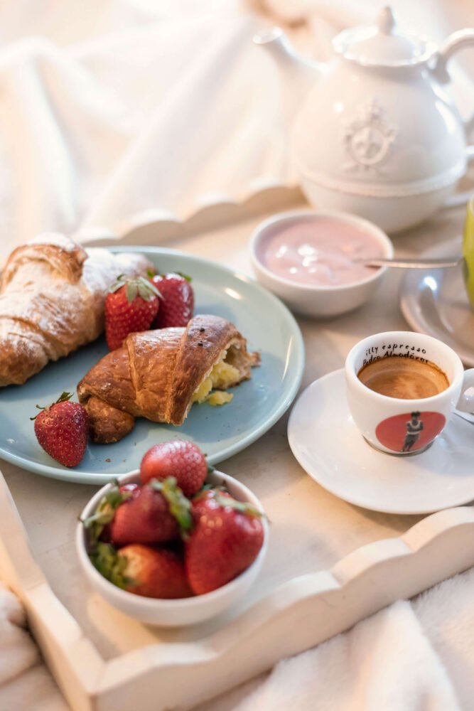 breakfast in bed with croissants and fresh strawberries and espresso coffe in san vincenzo