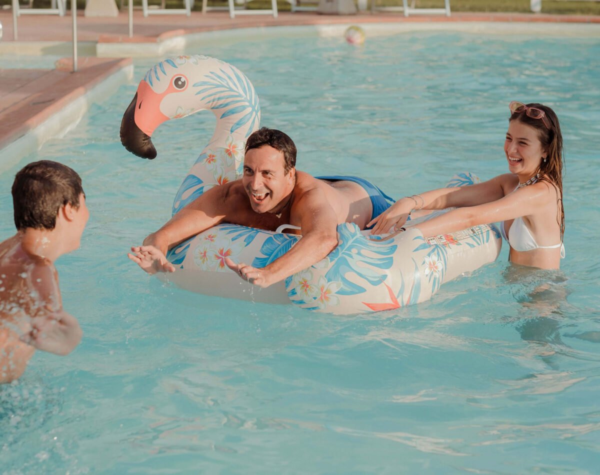 family playing by the pool at podere l'agave San Vincenzo